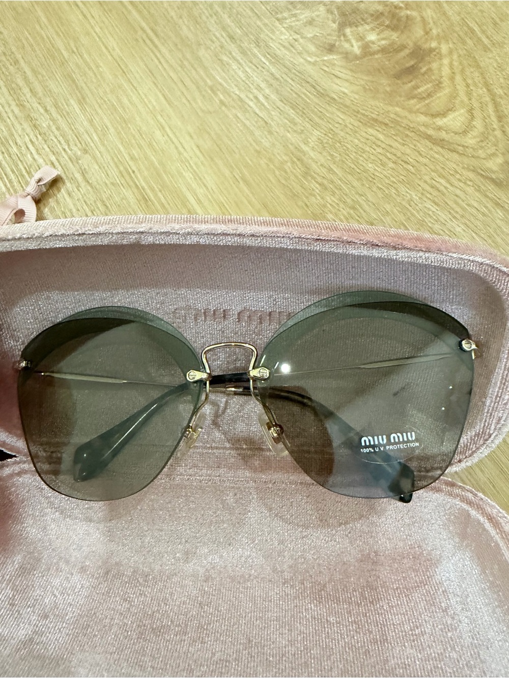 Miu Miu Oversized Rimless Sunglasses with Gray Lenses and Gold Bridge